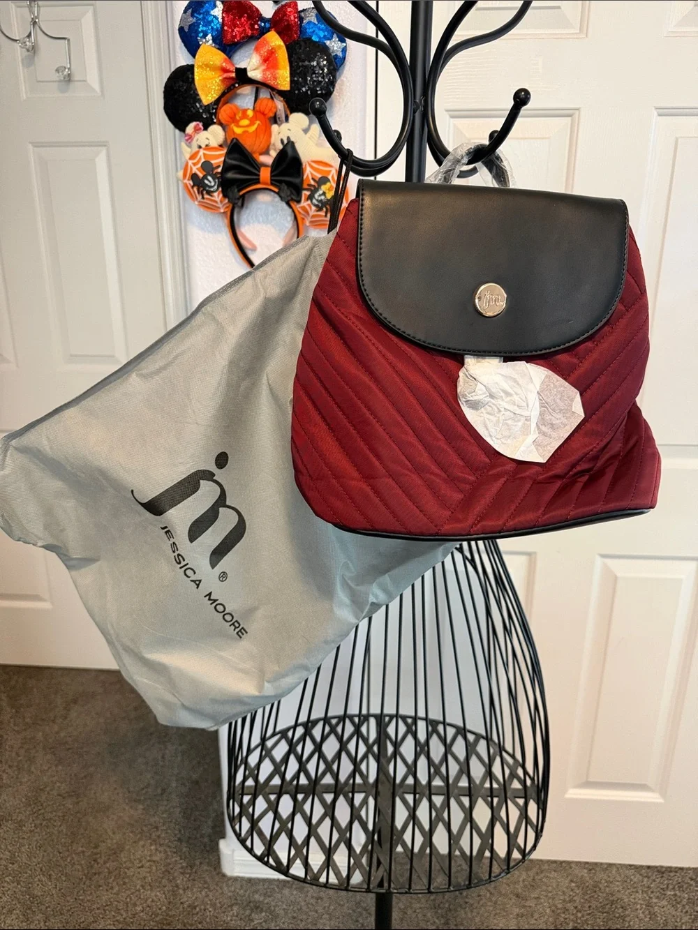 NWT Jessica Moore Burgundy Quilted Backpack with Black Flap Snap closures.